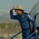 A screenshot of Jeff Bezos giving a high five after landing from his Blue Origin flight.